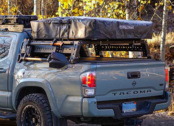 A ratchet strap hooked to the rear cover cleat.