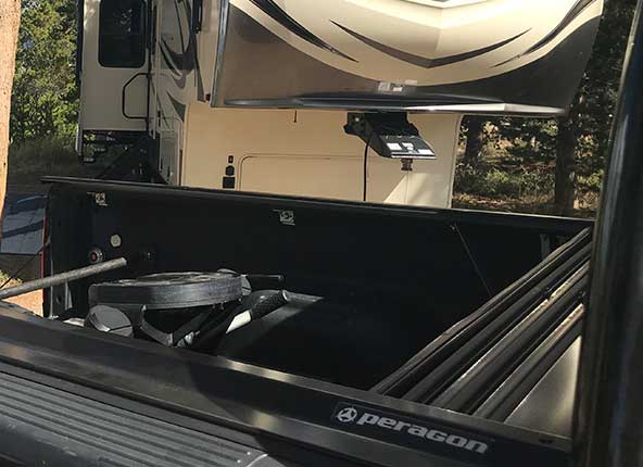 A ratchet strap hooked to the front cover cleat